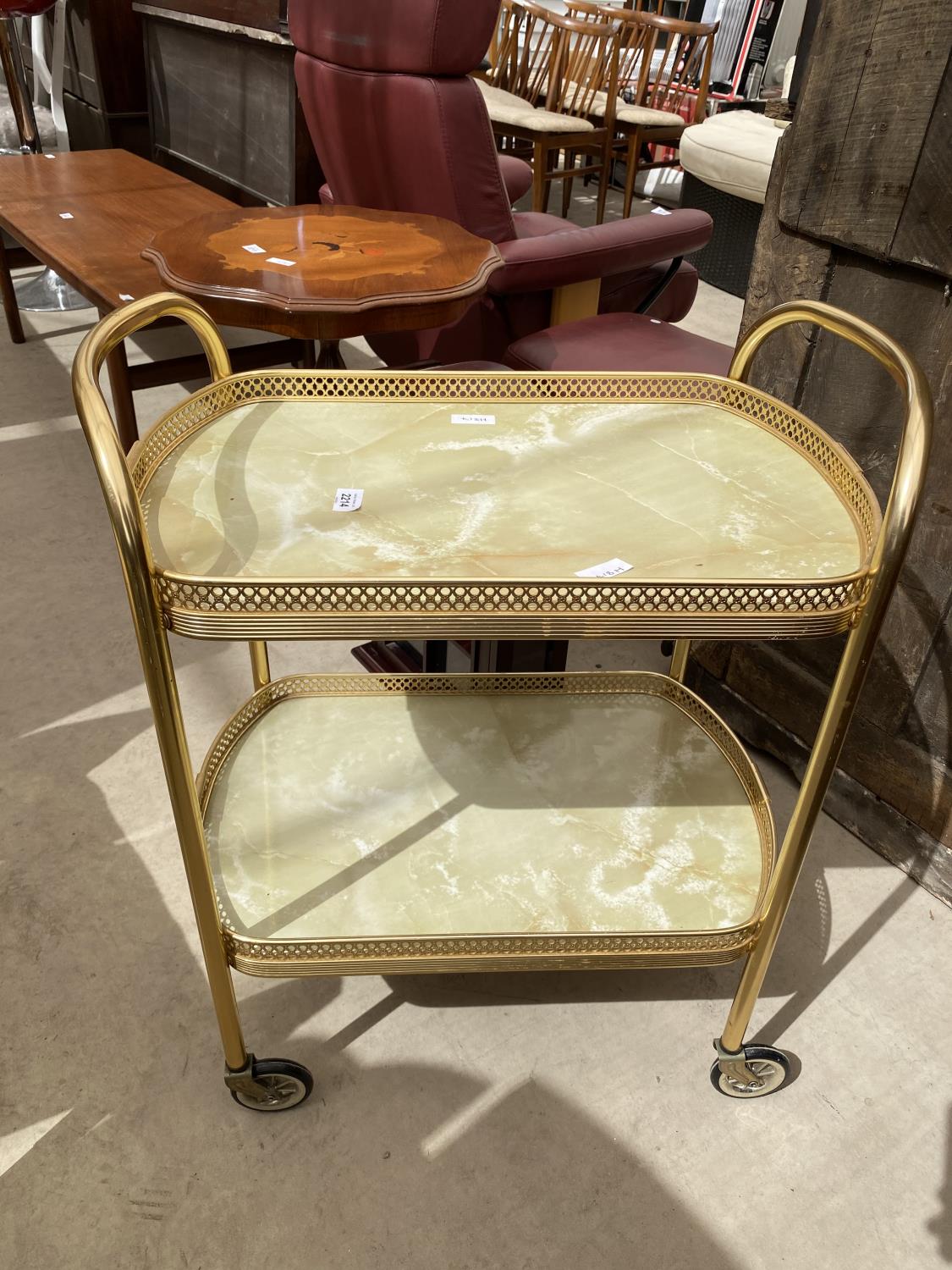A 1970'S GOLD COLOURED TROLLEY WITH MARBLE EFFECT TILES