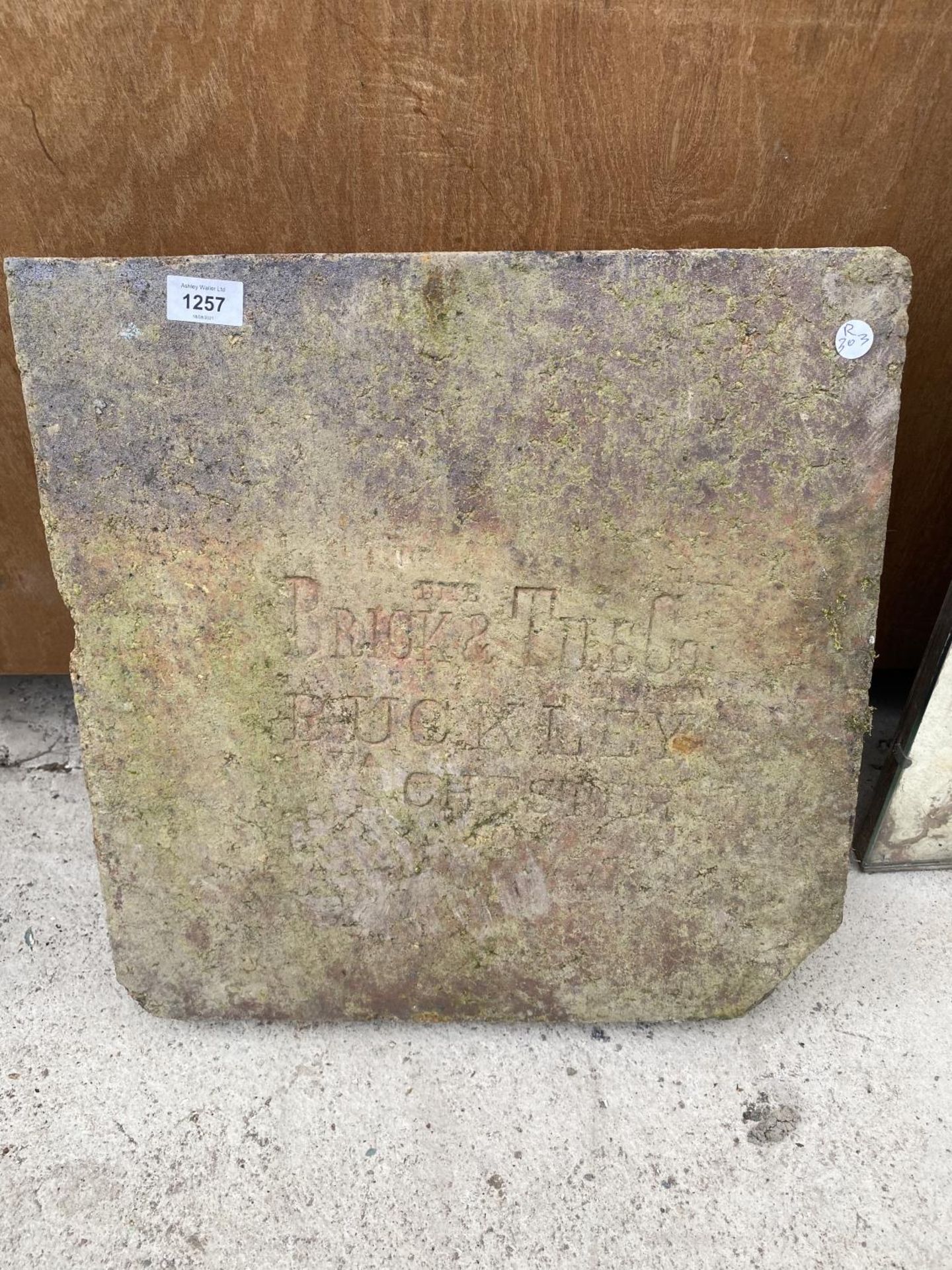 A PIECE OF STONE, ENGRAVED 'THE BRICK AND TILE CO. BUCKLEY CHESTER'