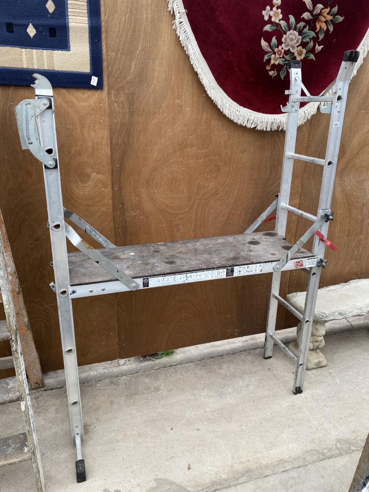 AN ALLUMINIUM MULTI POSITION LADDER WITH A DECORATORS PLATFORM