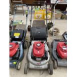A HONDA PETROL LAWN MOWER, ENGINE BELIEVED IN WORKING ORDER BUT NO WARRANTY AND SLIGHT DAMAGE TO THE