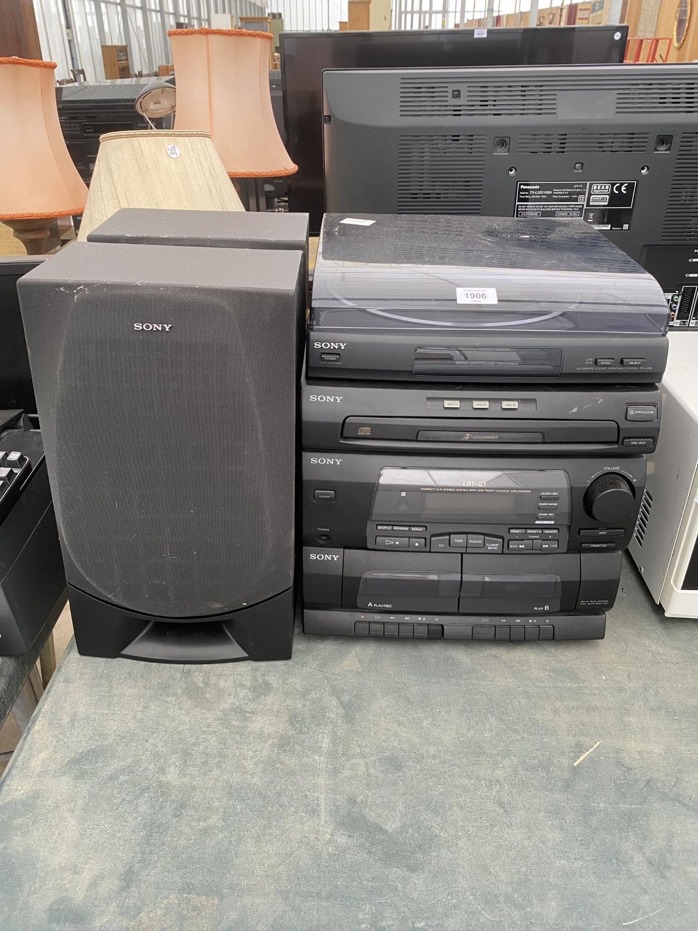 A SONY STEREO SYSTEM WITH RECORD PLAYER, THREE CD CHANGER, TAPE DECK AND TWO SPEAKERS