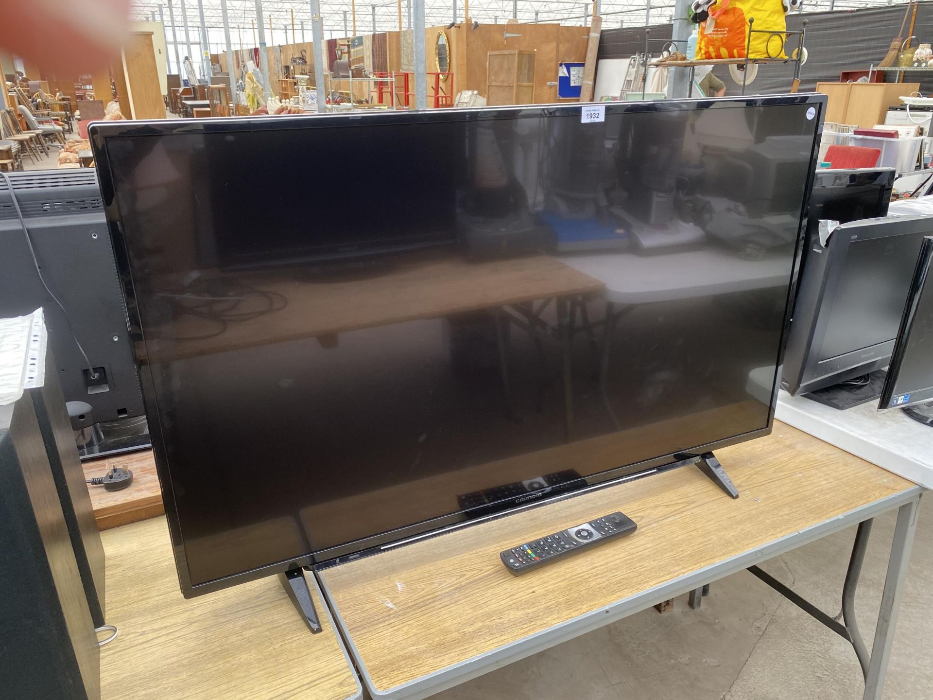 A 49" GRUNDIG FLATSCREEN TELEVISION WITH REMOTE BELIEVED IN WORKING ORDER BUT NO WARRANTY