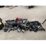 AN ASSORTMENT OF AUTOMOBILE PARTS AND SPARES TO INCLUDE HEAD LIGHTS, GEAR STICK AND HAND BREAK ETC