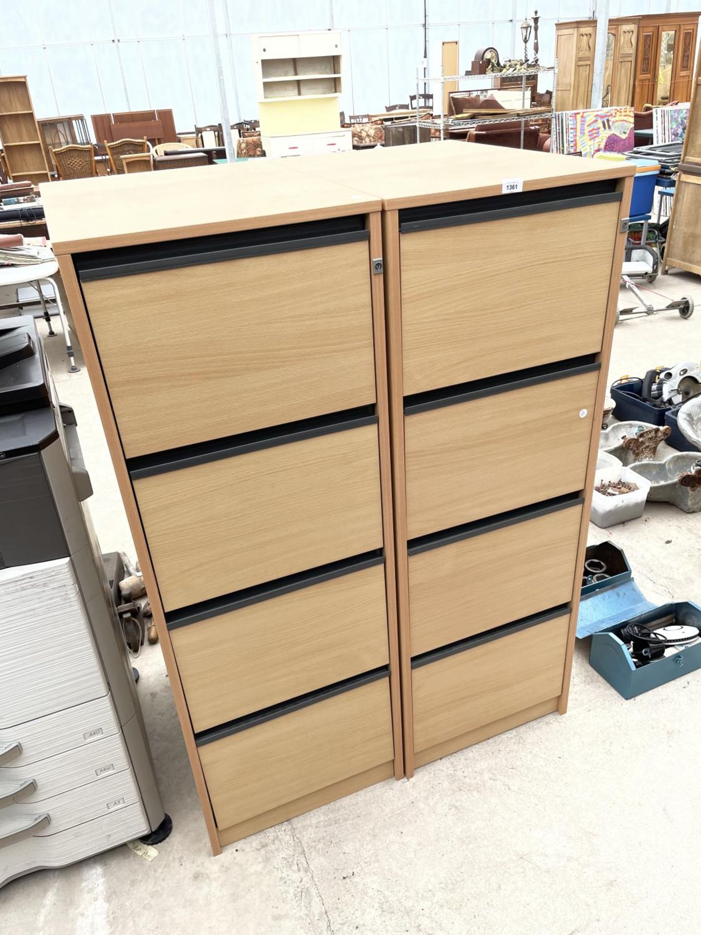 A PAIR OF FOUR DRAWER WOODEN FILING CABINETS