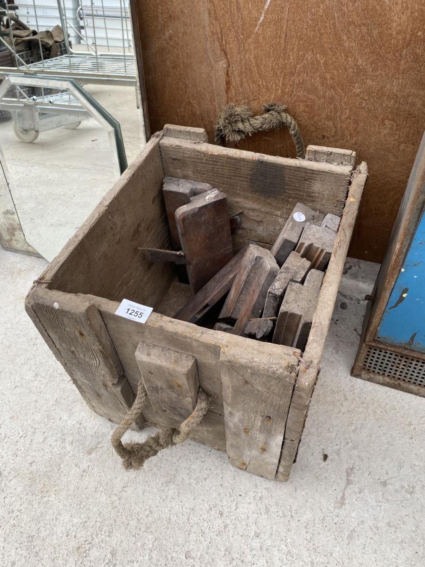 A VINTAGE WOODEN CRATE CONTAINING A QUANTITY OF VINTAGE WOOD PLANES