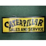 A 'CATERPILLAR SALES AND SERVICE' ILLUMINATED SIGN