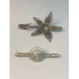 TWO SILVER BROOCHES TO INCLUDE ONE WITH A DELICATE FLOWER DESIGN