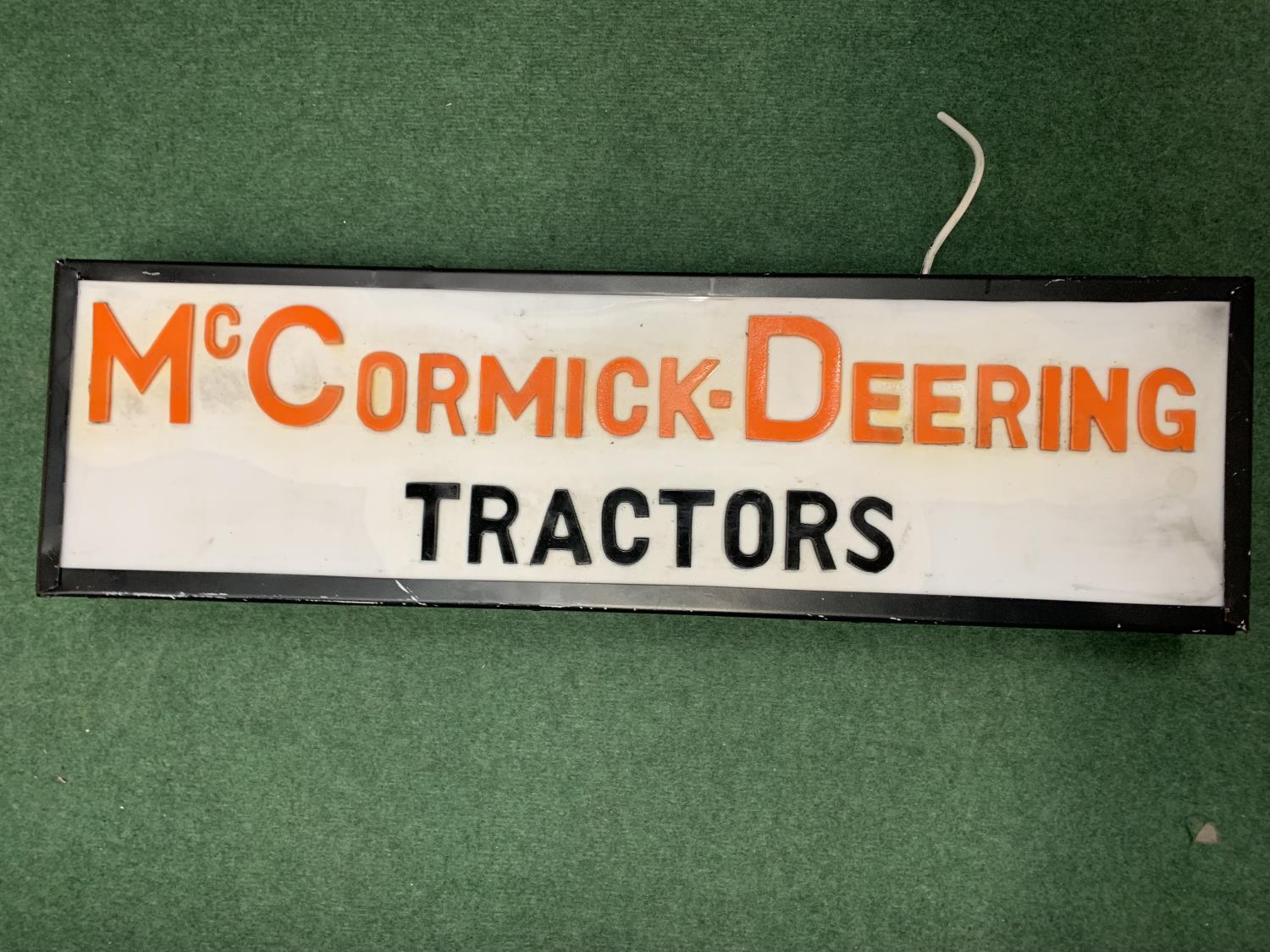 A McCORMICK-DEERING TRACTORS ILLUMINATED SIGN