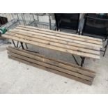 A GROUP OF FOUR WOODEN SLATTED GYM BENCHES WITH METAL LEGS