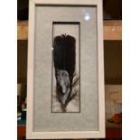 A FRAMED FEATHER DELICATELY PAINTED WITH A UNICORN HEAD