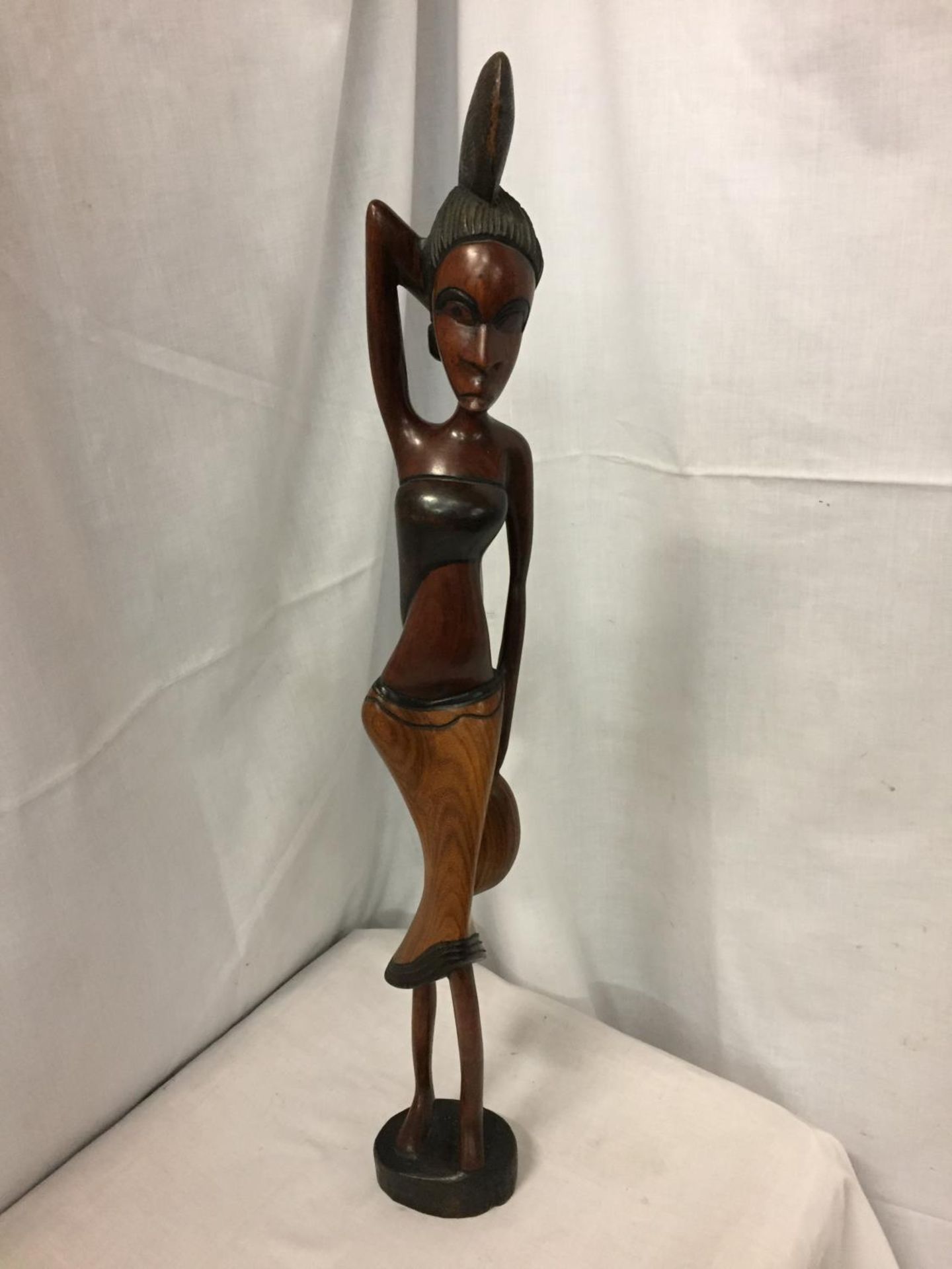 A CARVED WOODEN TRIBAL FIGURE OF A LADY H:65CM