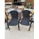 A SET OF FOUR METAL FRAMED BISTRO CHAIRS WITH RATTAN STYLE SEATS