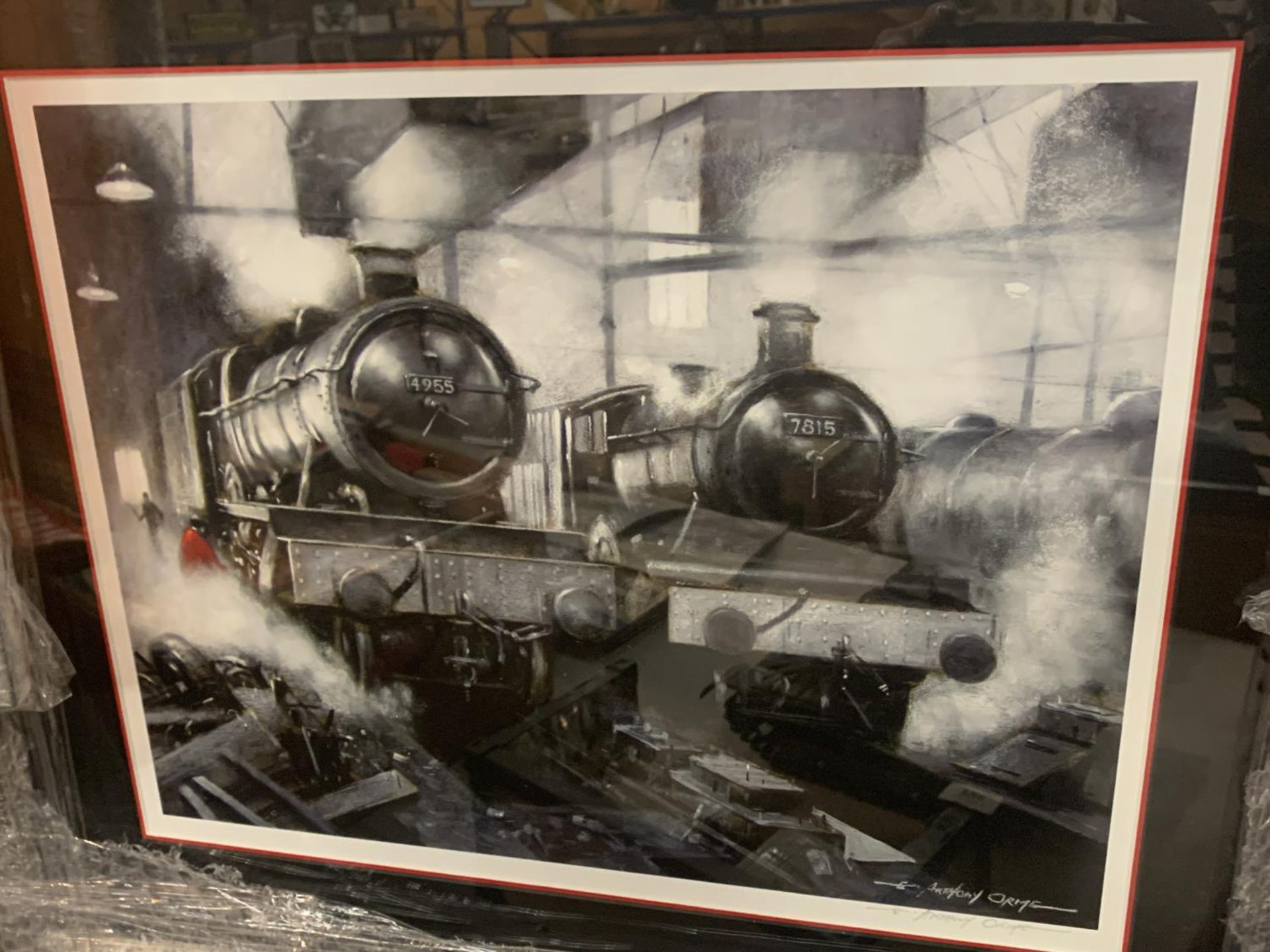 THREE BLACK AND WHITE FRAMED PRINTS OF STEAM ENGINES WITH WITH A MAN DRESSED IN RED IN EVERY PICTURE - Image 3 of 4