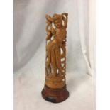 A CARVED BALINESE FIGURE 23CM HIGH