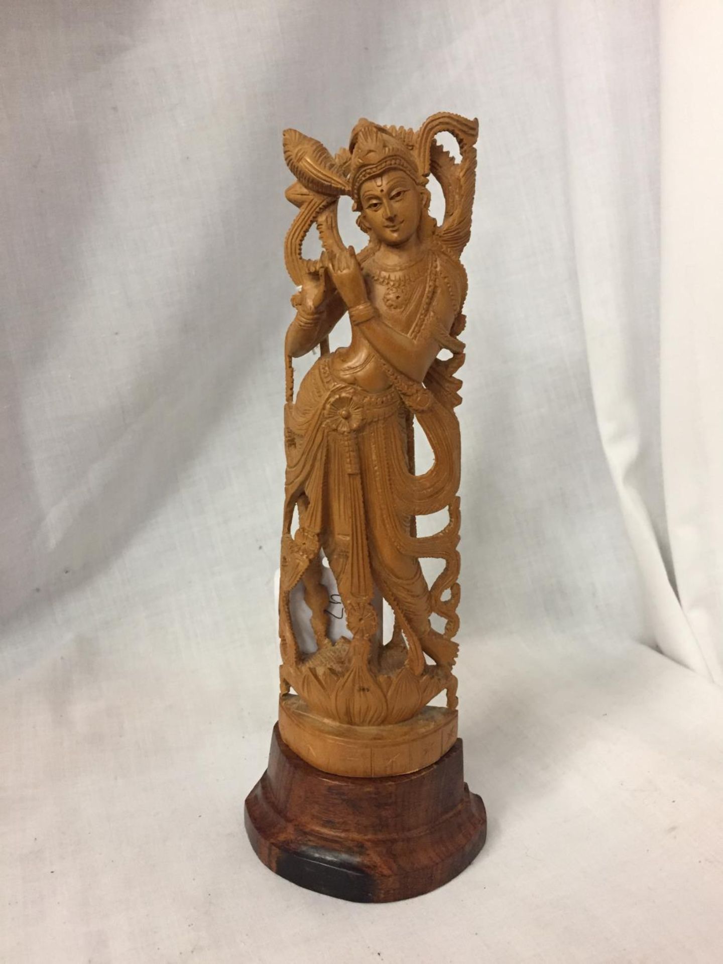 A CARVED BALINESE FIGURE 23CM HIGH