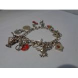 A SILVER CHARM BRACELET WITH 13 CHARMS