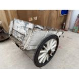 A VINTAGE PAINTED WOODEN MARKET GARDENERS TWO WHEELED TROLLEY WITH METAL BANDED WHEELS AND TWO