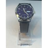 A LORUS DAY AND DATE WRIST WATCH ON A PRESENTATION STAND SEEN WORKING BUT NO WARRANTY