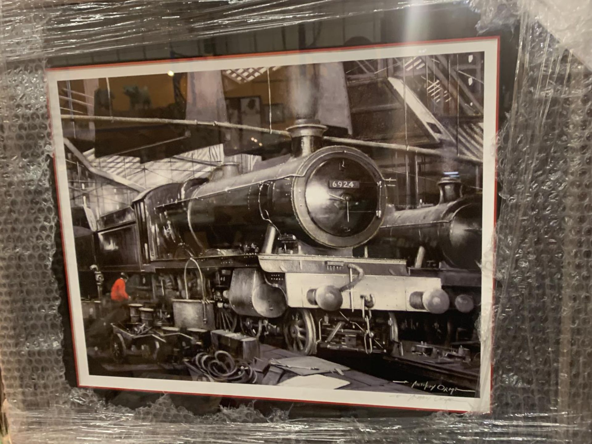 THREE BLACK AND WHITE FRAMED PRINTS OF STEAM ENGINES WITH WITH A MAN DRESSED IN RED IN EVERY PICTURE - Image 4 of 4