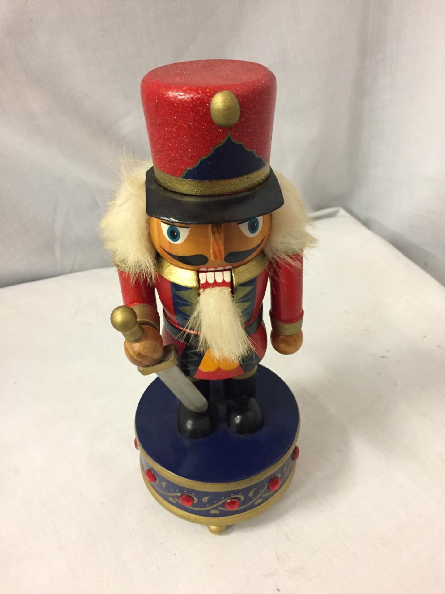 A STEINBACH STYLE NUTCRACKER ON A MUSIC BOX BASE