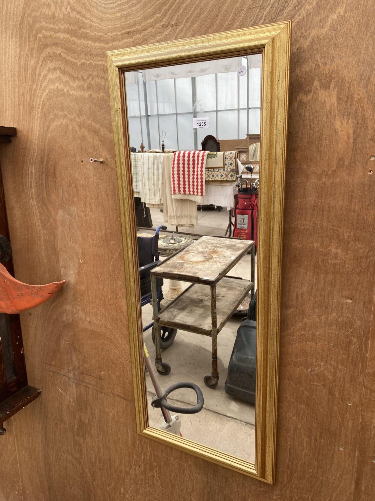 A GILT FRAMED MIRROR