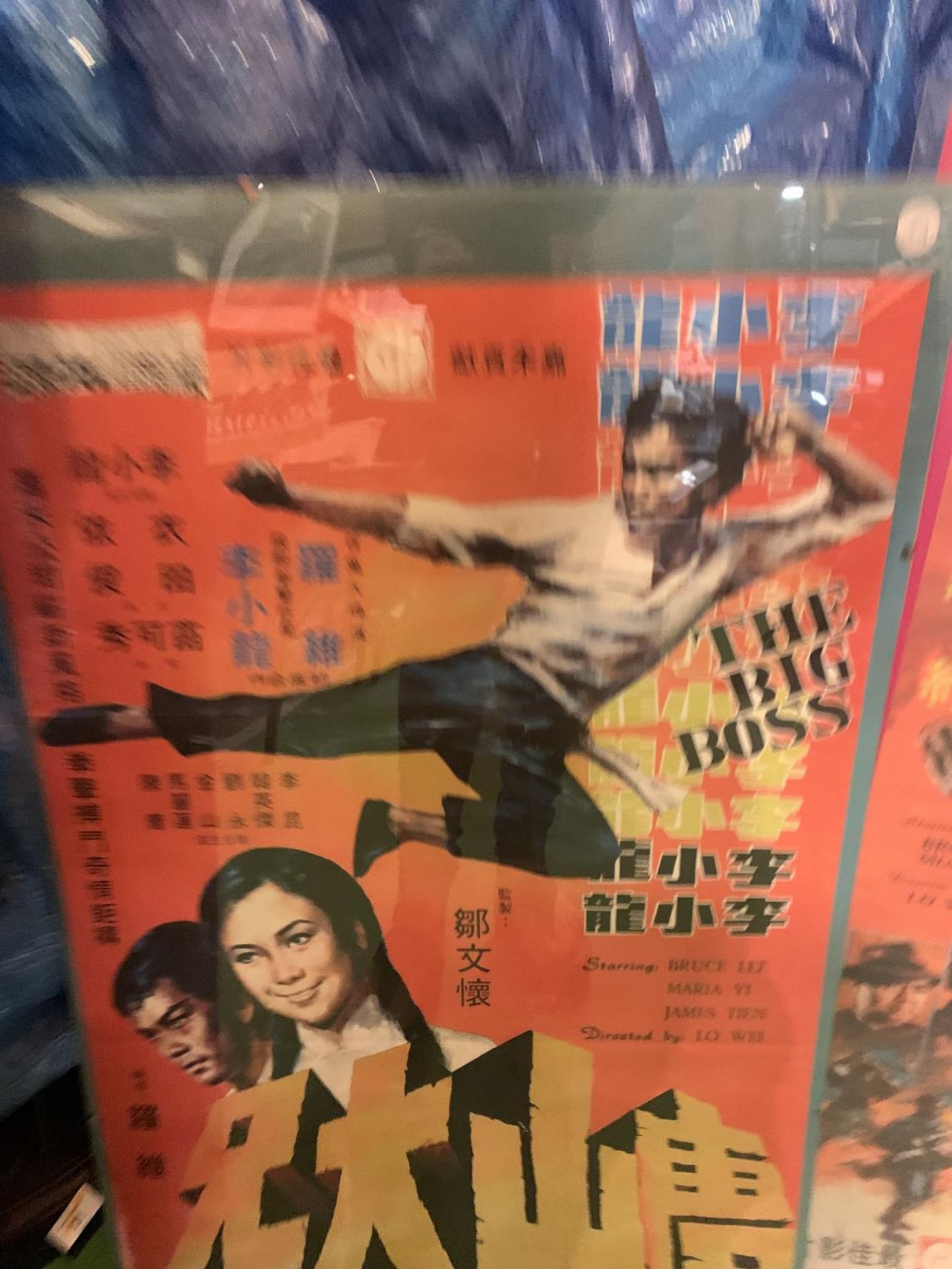 A POSTER ADVERTISNG BRUCE LEE AND THE BIG BOSS MOUNTED IN PERSPEX