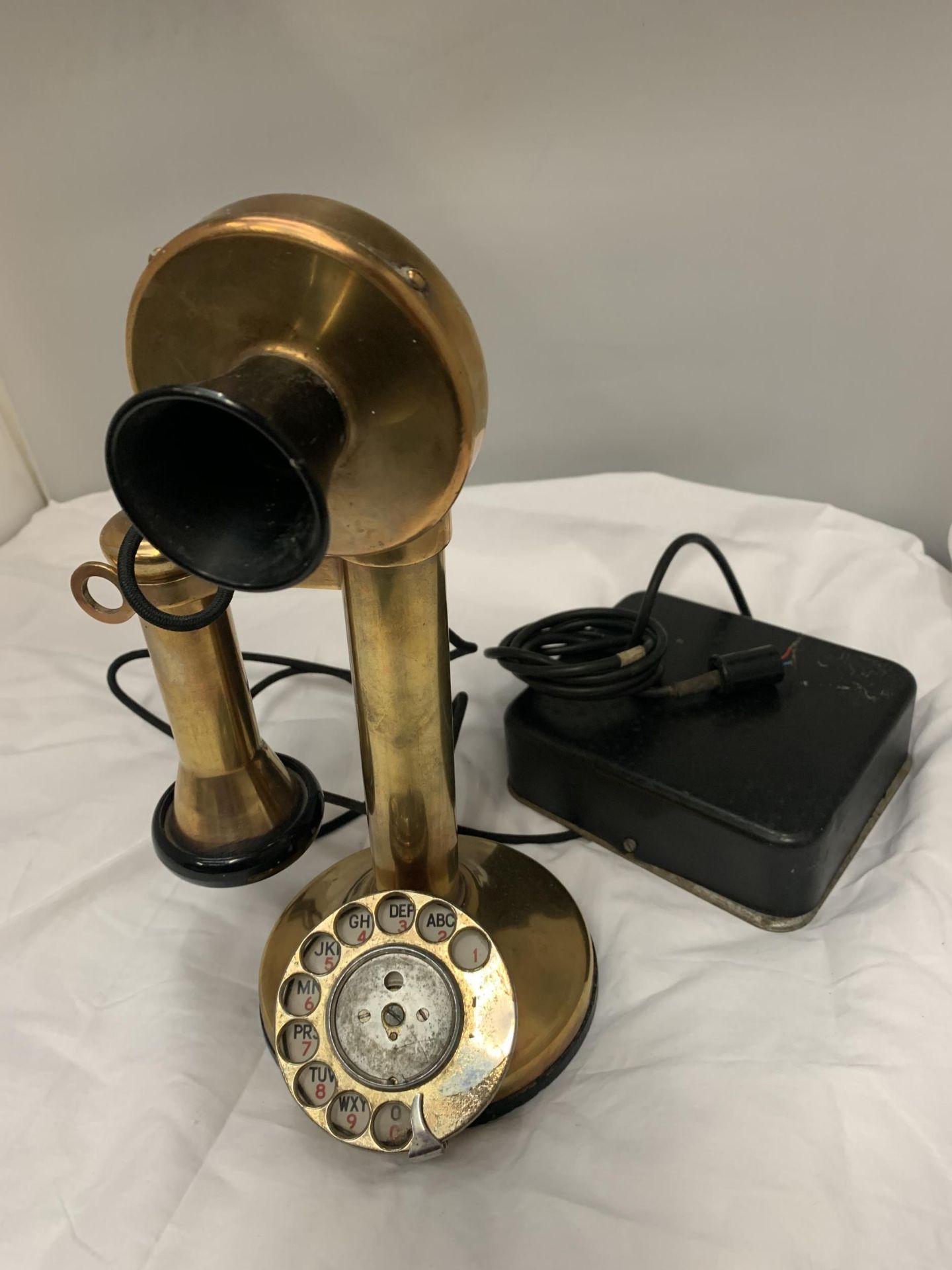 A BRASS 'CANDLESTICK' ROTARY DIAL TELEPHONE WITH EAR PIECE AND BOX