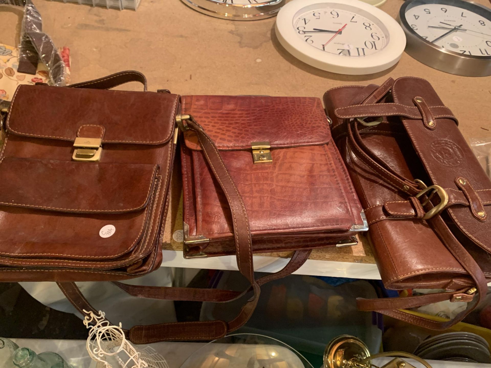 THREE BROWN LEATHER CROSS BODY BAGS
