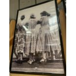 A VERY LARGE KODAK BLACK AND WHITE FRAMED 1940'S/1950'S PRINT OF THREE LADIES ON A PIER 156CM X