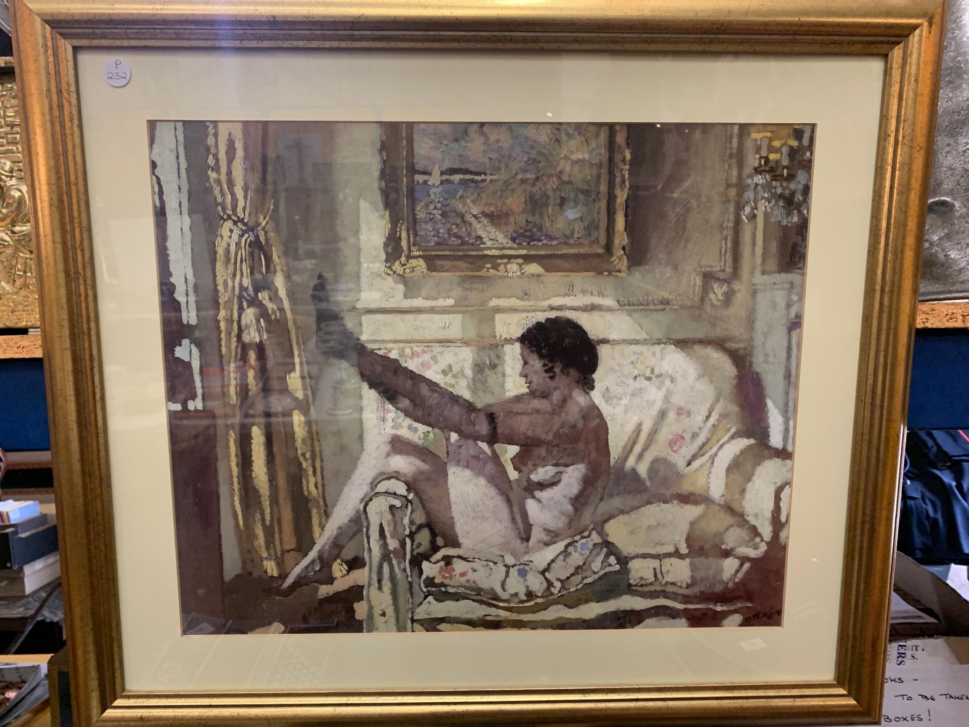 A GILT FRAMED PICTURE OF A LADY PUTTING HER STOCKINGS ON