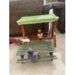 A COLLECTION OF SAMLL WOODEN DOLLS WITH A PICNIC TABLE AND SWING SEAT
