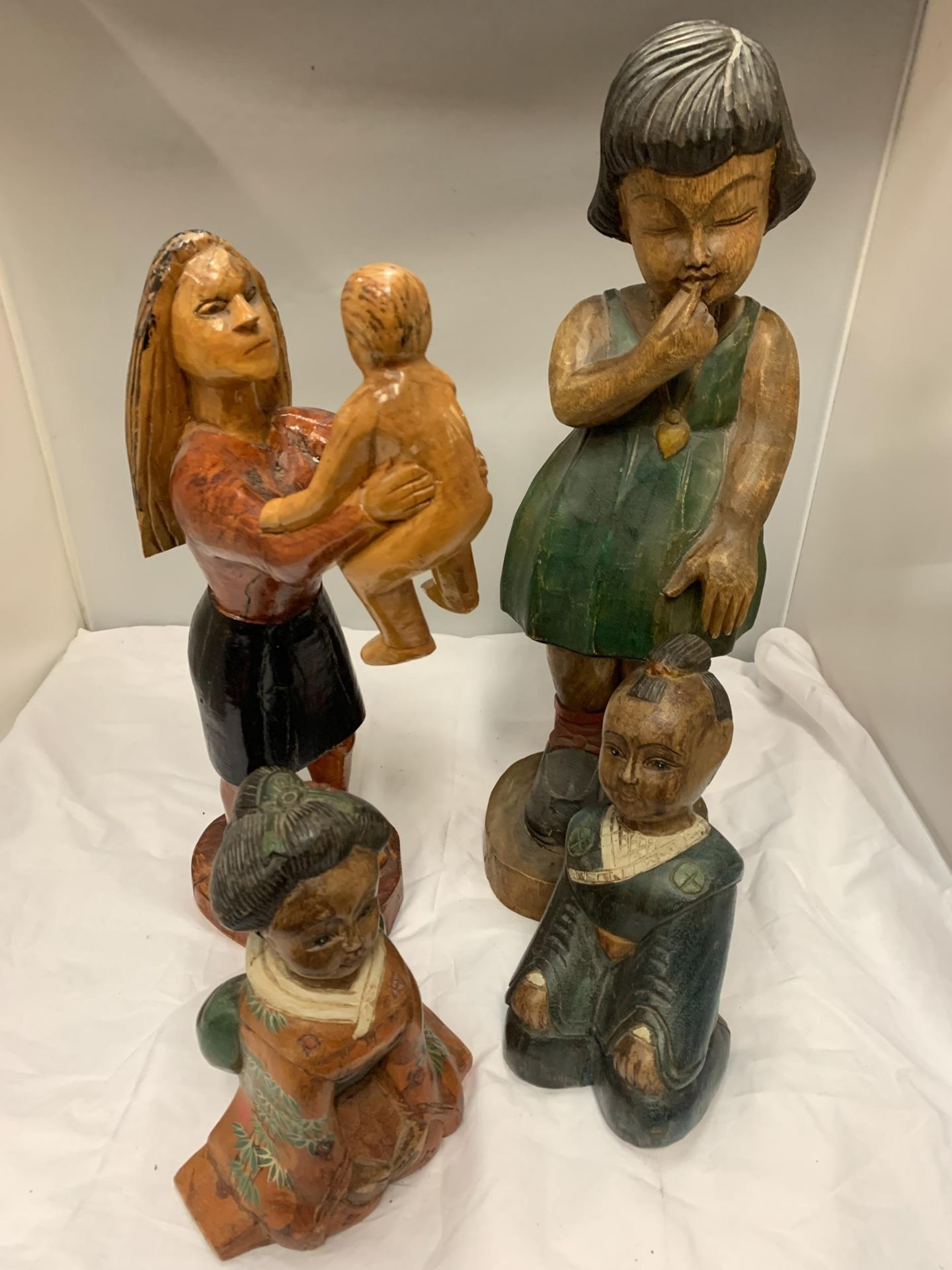 A COLLECTION OF FOUR WOODEN CARVED FIGURES