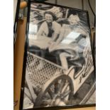 A VERY LARGE KODAK BLACK AND WHITE FRAMED 1940'S/1950'S PRINT OF TWO LADIES ON A FAIRGROUND RIDE