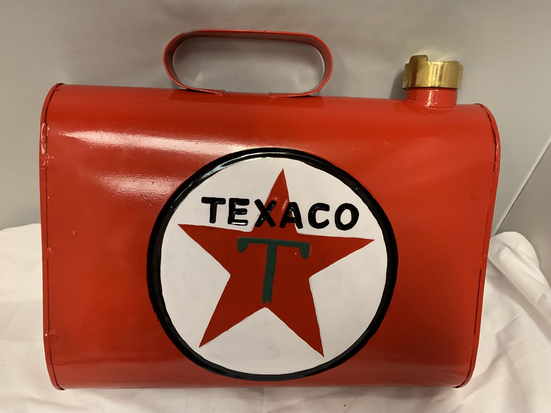 A RED TEXACO WALL HANGING CAN