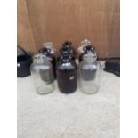 A COLLECTION OF NINE GLASS DEMI JOHNS (FOUR CLEAR, FIVE BROWN)