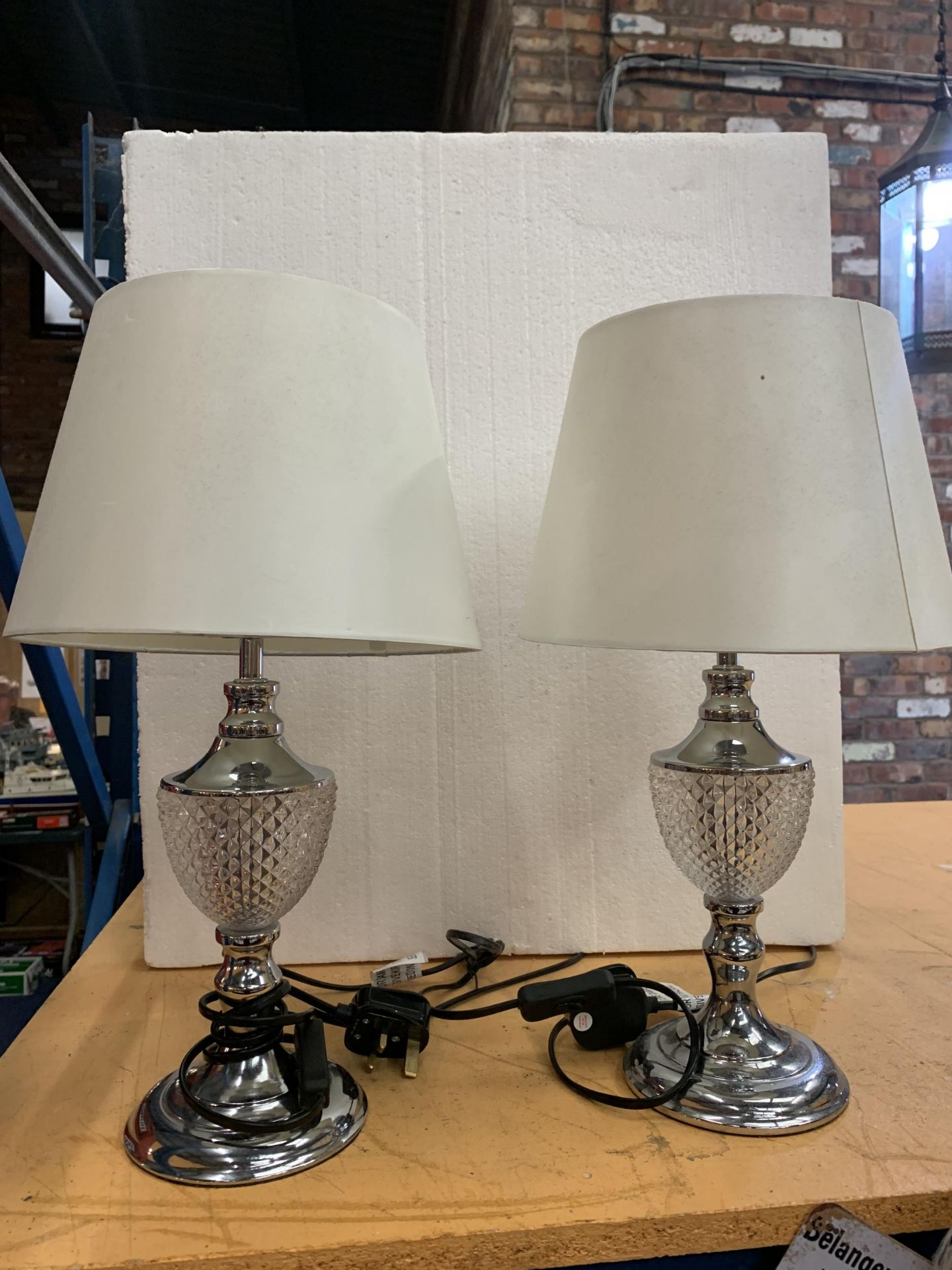 A PAIR OF CHROME AND GLASS TABLE LAMPS