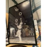 A VERY LARGE KODAK BLACK AND WHITE FRAMED 1940'S/1950'S PRINT OF A MALE CIRCUS PERFORMER 156CM X