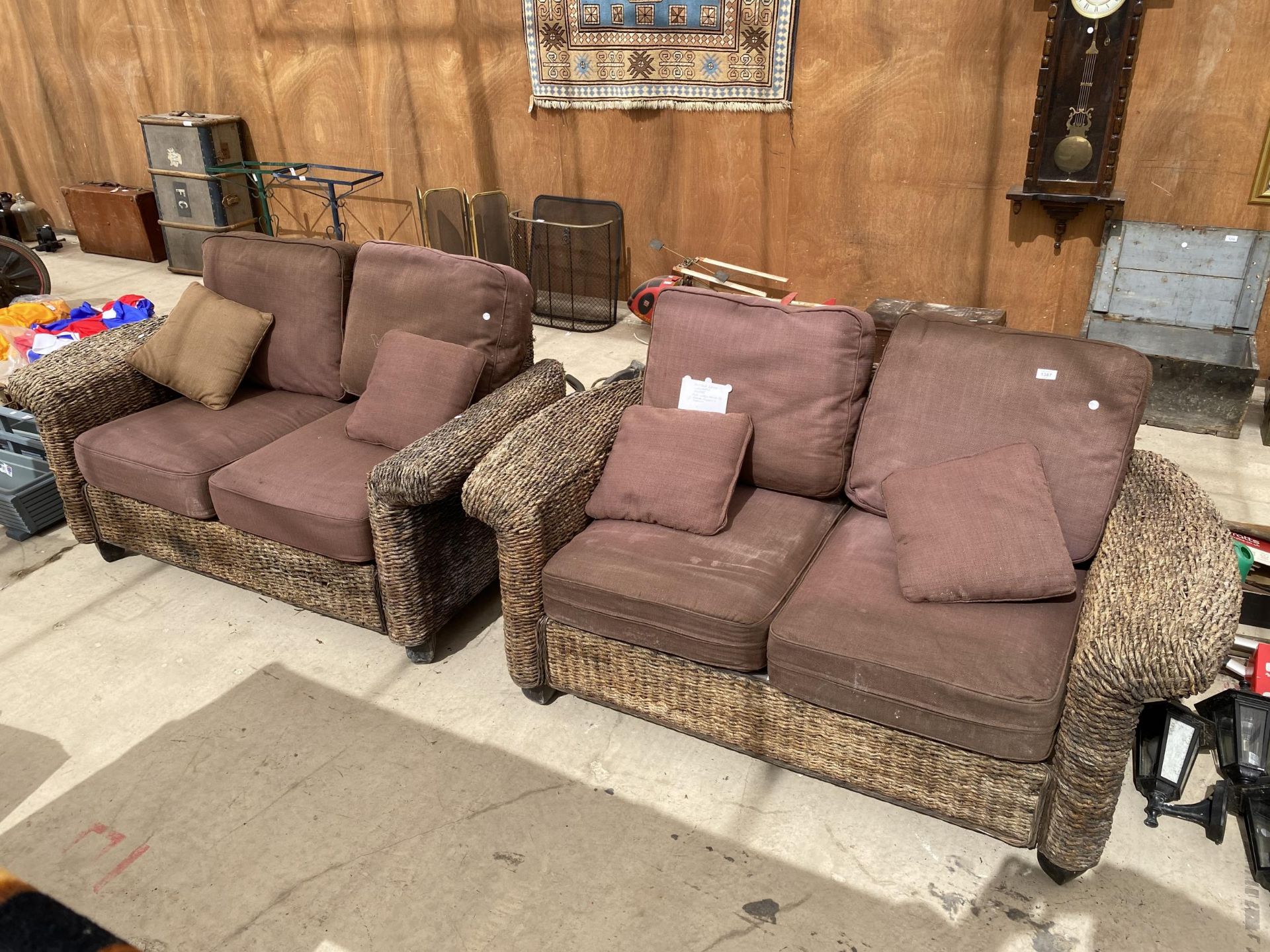 A PAIR OF OUTSIDE WICKER/RATTAN TWO SEATER SOFAS WITH WASHABLE CUSHION COVERS