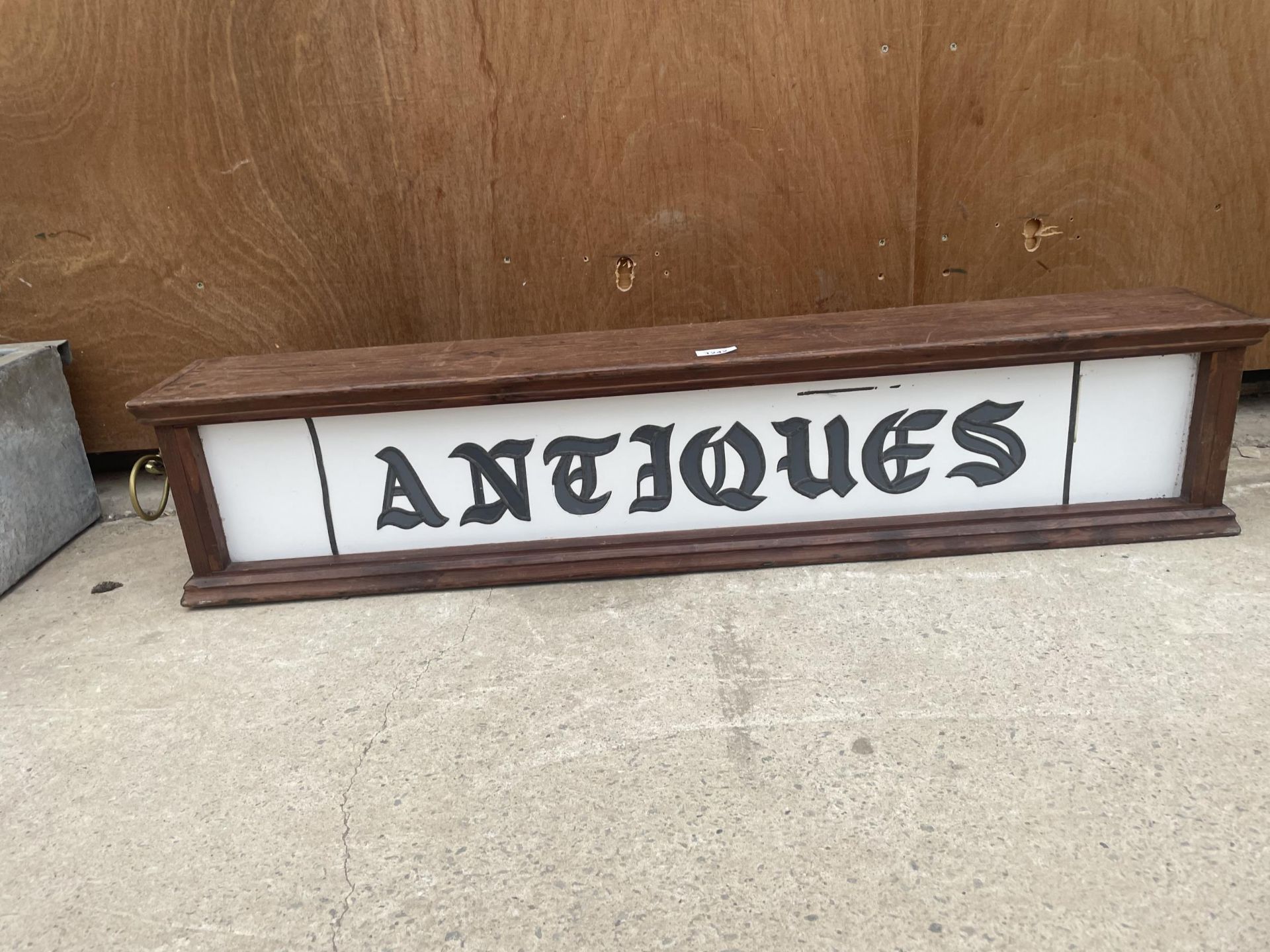 A WOODEN CASED ILLUMINATED 'ANTIQUES' SIGN