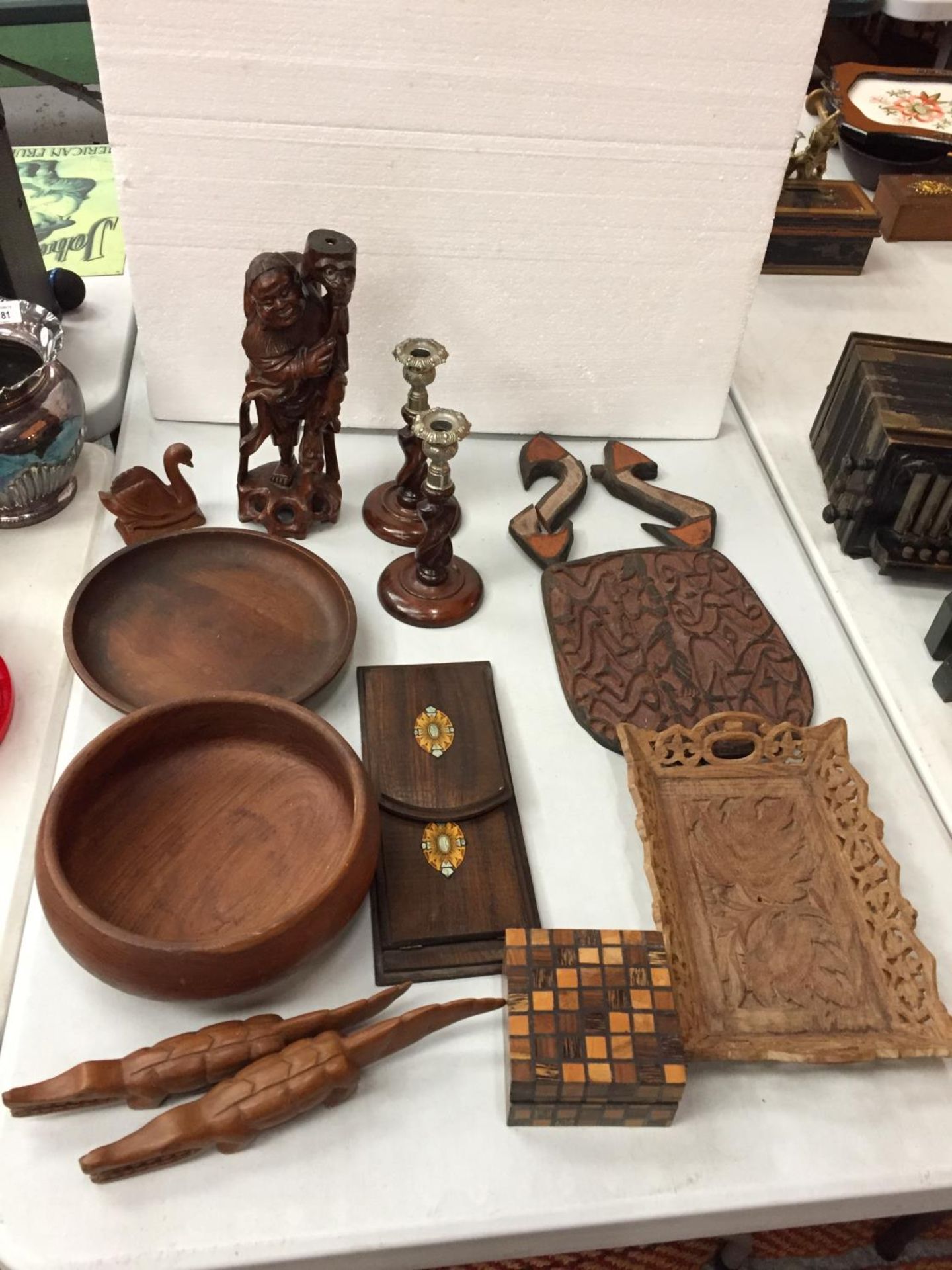 A SELECTION OF TREEN TO INCLUDE A BOOK STAND, A PAIR OF CANDLESTICKS, TRIBAL FIGURINES AND A