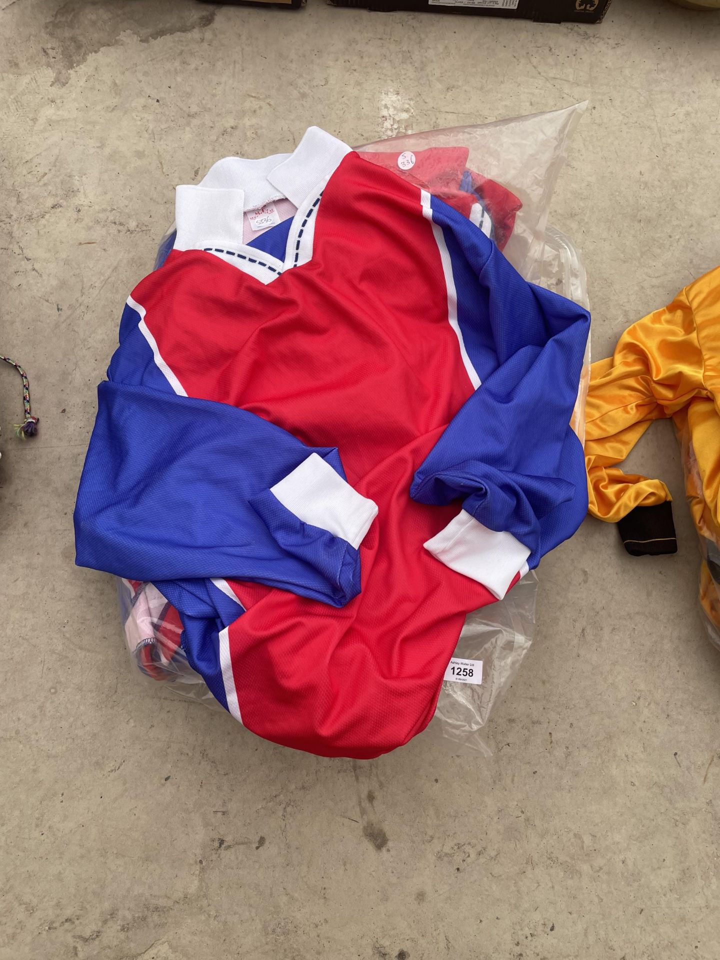 A COLLECTION OF BLUE, RED AND WHITE M.G SPORTSWEAR FOOTBALL TOPS