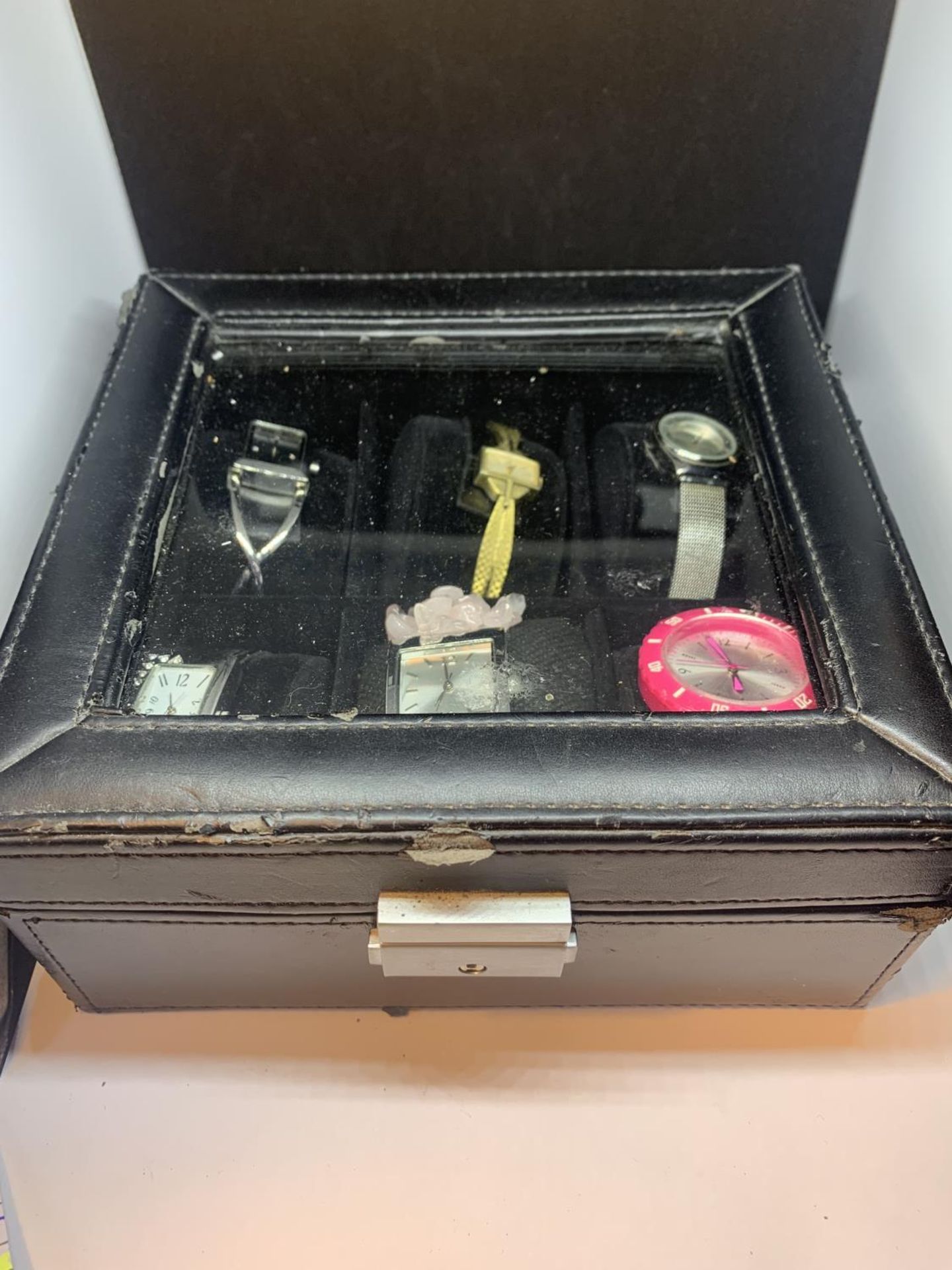 A BLACK WRIST WATCH DISPLAY BOX WITH SIX WATCHES SEEN WORKING BUT NO WARRANTY