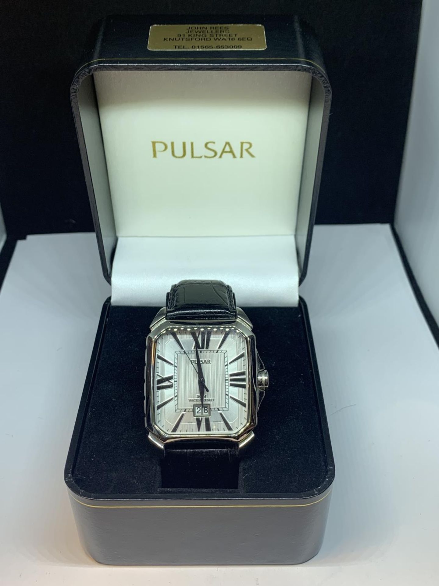 A PULSAR CALENDAR WRIST WATCH WITH LARGE SQUARE FACE AND BLACK LEATHER STRAP IN A PRESENTATION BOX