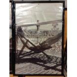 A VERY LARGE KODAK BLACK AND WHITE FRAMED 1940'S/1950'S PRINT OF A LADY SUNNING HERSELF ON THE