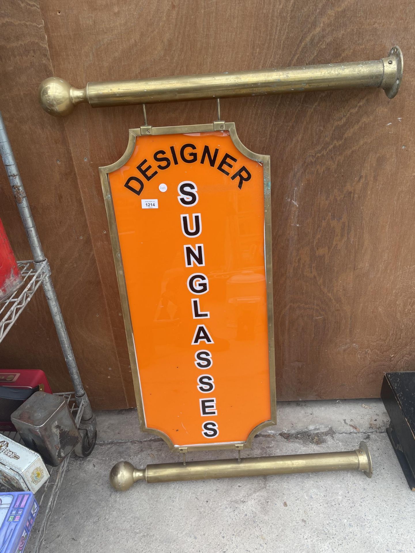 A BRASS SHOP DISPLAY SIGN FOR 'DESIGNER SUNGLASSES'