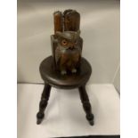 A SMALL OAK STOOL HEIGHT 24CM WITH A WOODEN OWL DESIGN WALL BOX CONTAINING SHOE CLEANING BRUSHES