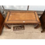 AN ORIENTAL HARDWOOD COFFEE TABLE WITH ALL ROUND FRETWORK DECORATION, 38 X 17"