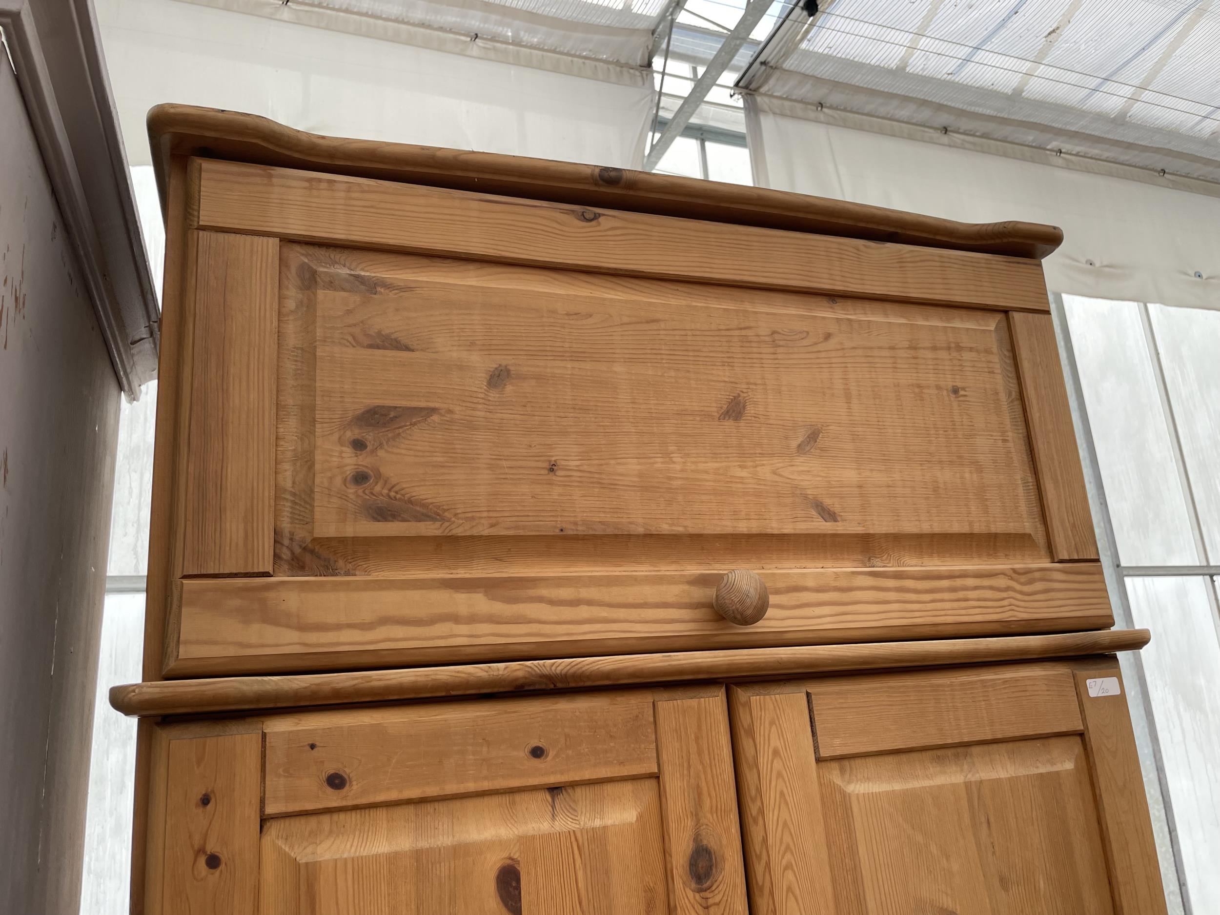 A MODERN PINE TWO DOOR WARDROBE WITH A DRAWER TO THE BASE AND TOP BOX 35" WIDE - Image 2 of 4