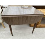 A MID 20TH CENTURY CREAMY WALNUT EFFECT DROP-LEAF DINING TABLE