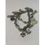 A SILVER BRACELET WITH THIRTEEN CHARMS A GENIE LAMP, LIVERPOOL FOOTBALL CLUB BADGE, ELEPHANT,